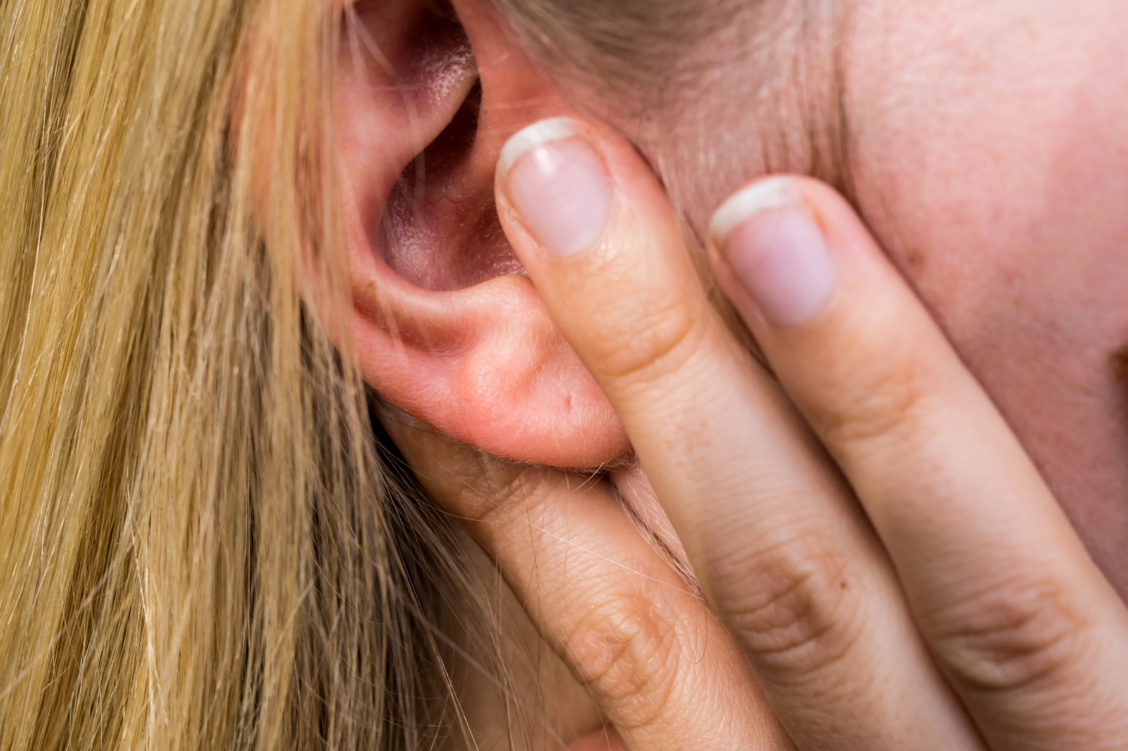 Person using ear cleansing tool to remove blackheads in ear canal